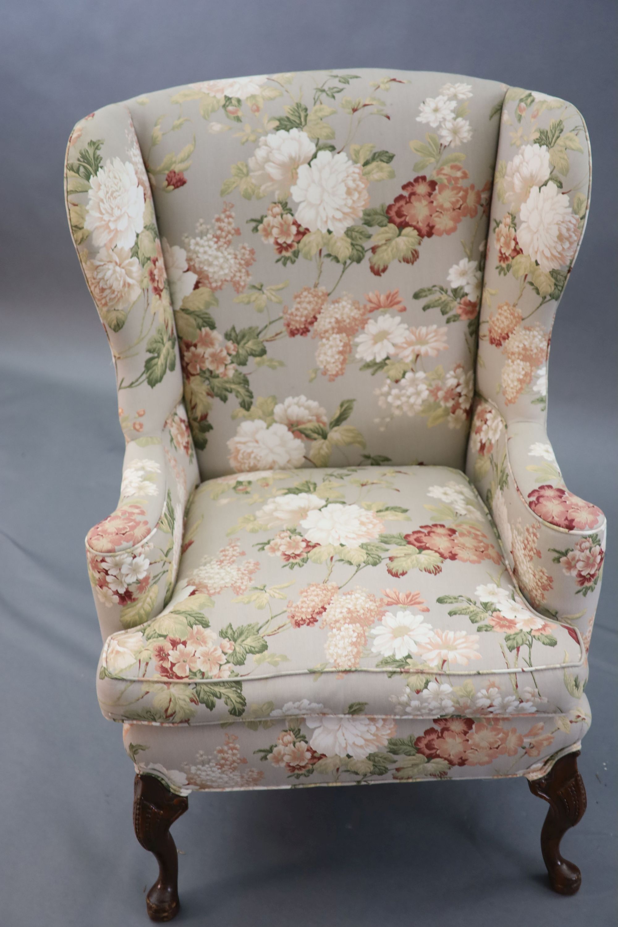 A French Hepplewhite style wing armchair together with a matching contemporary footstool